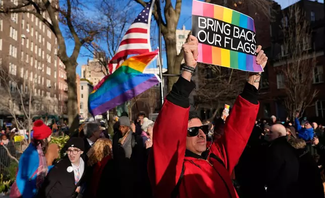 People demonstrate after New York politicians and activists raised a rainbow flag on a pole across the street from the Stonewall Inn, Thursday, Feb. 12, 2026, in New York, a few days after it was removed by the National Park Service to comply with guidance from the Trump administration. (AP Photo/Yuki Iwamura)