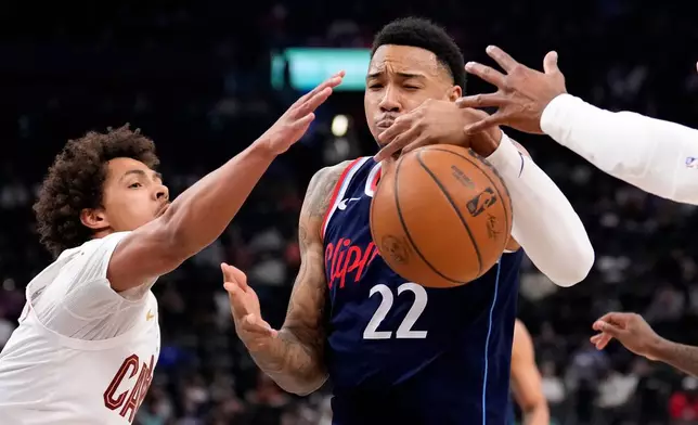 Cleveland Cavaliers guard Craig Porter Jr., left, reaches in on Los Angeles Clippers guard Jordan Miller during the first half of an NBA basketball game Wednesday, Feb. 4, 2026, in Inglewood, Calif. (AP Photo/Mark J. Terrill)