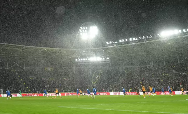 A heavy rain falls during the English FA Cup fourth round soccer match between Hull City and Chelsea in Hull, England, Friday, Feb. 13, 2026. (AP Photo/Jon Super)