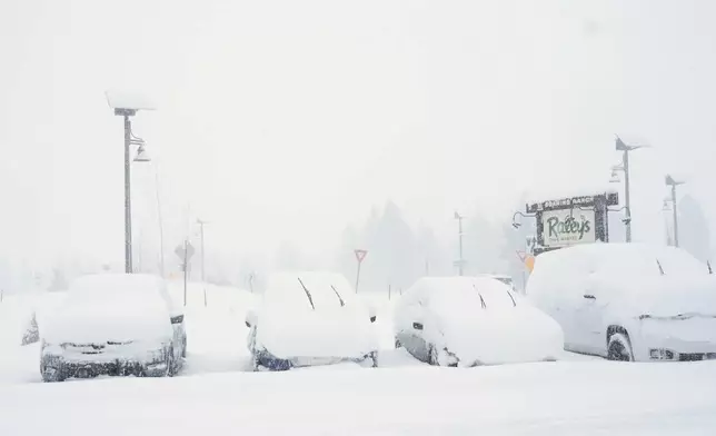 Cars are covered in snow during a snow storm on Tuesday, Feb. 17, 2026 in Truckee Calif. (AP Photos/Brooke Hess-Homeier)