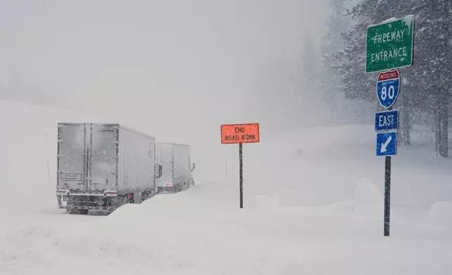 Trucks are lined up along Interstate 80 during a storm on Tuesday, Feb. 17, 2026 in Truckee Calif. (AP Photos/Brooke Hess-Homeier)