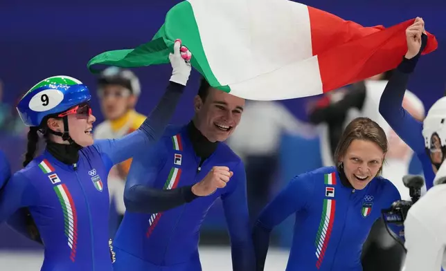 Team Italy celebrate as they take the gold in the team mixed relay short track speed skating at the 2026 Winter Olympics, in Milan, Italy, Tuesday, Feb. 10, 2026. (AP Photo/Stephanie Scarbrough)
