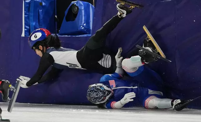 Corinne Stoddard, below, of the United States crashes into Kim Gilli of South Korea while competing in the team mixed relay short track speed skating at the 2026 Winter Olympics, in Milan, Italy, Tuesday, Feb. 10, 2026. (AP Photo/Stephanie Scarbrough)