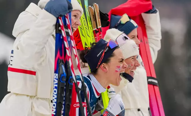 Heidi Weng, of Norway, center, and her teammates celebrate after winning the gold medal in the cross country skiing women's 4 x 7.5km relay at the 2026 Winter Olympics, in Tesero, Italy, Saturday, Feb. 14, 2026. (AP Photo/Matthias Schrader)
