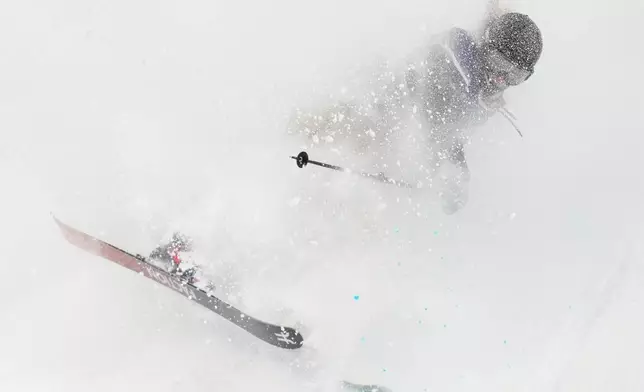 Switzerland's Sarah Hoefflin lands as she competes in the women's freestyle skiing big air qualifications at the 2026 Winter Olympics, in Livigno, Italy, Saturday, Feb. 14, 2026. (AP Photo/Abbie Parr)