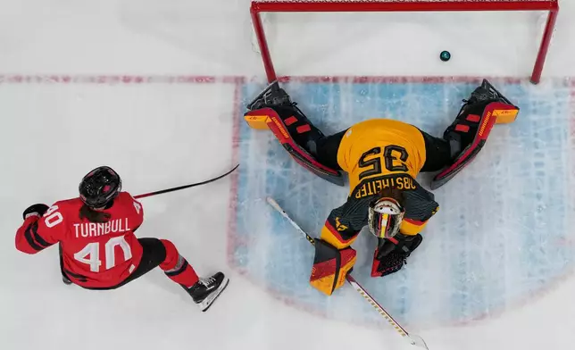 Canada's Blayre Turnbull (40) scores her side's fourth goal during a women's quarterfinal ice hockey game between Canada and Germany at the 2026 Winter Olympics, in Milan, Italy, Saturday, Feb. 14, 2026. (AP Photo/Darko Bandic)