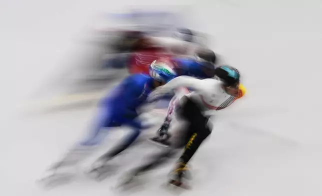Stijn Desmet of Belgium leads the pack during in the men's 1500 meter short track speed skating at the 2026 Winter Olympics, in Milan, Italy, Saturday, Feb. 14, 2026. (AP Photo/Francisco Seco)