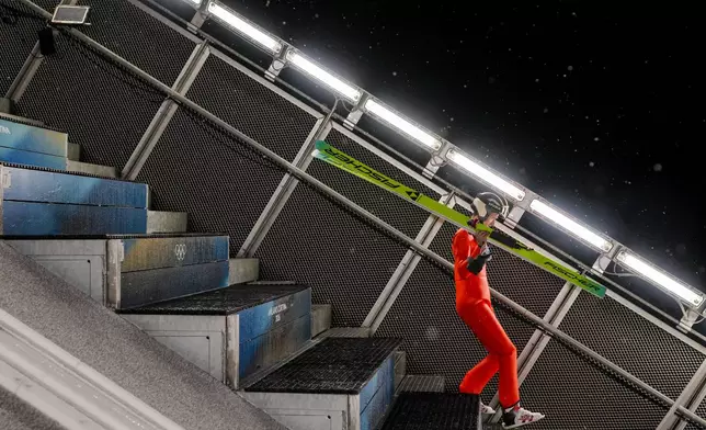Gregor Deschwanden, of Switzerland, walks at the ramp for his trial jump of the ski jumping men's large hill individual at the 2026 Winter Olympics, in Predazzo, Italy, Saturday, Feb. 14, 2026. (AP Photo/Evgeniy Maloletka)