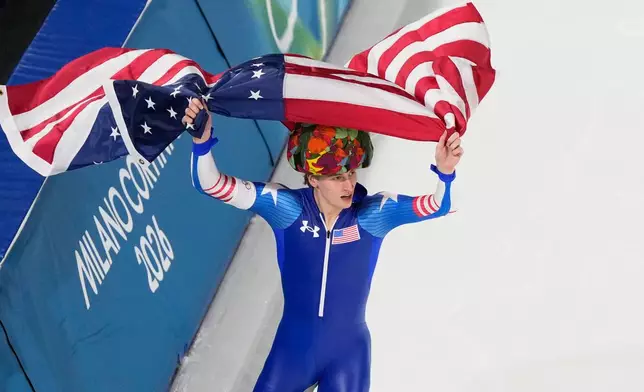 United States' Jordan Stolz celebrates after winning gold and setting a new Olympic record in the men's 500-meters speedskating final at the 2026 Winter Olympics, in Milan, Italy, Saturday, Feb. 14, 2026. (AP Photo/David J. Phillip)