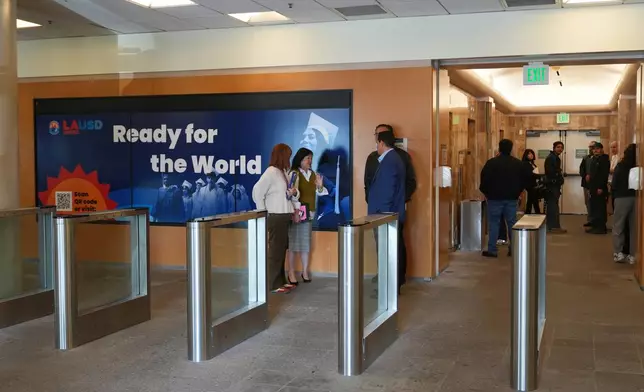 People stand in the lobby of the LAUSD headquarters Wednesday, Feb. 25, 2026, in Los Angeles. (AP Photo/Damian Dovarganes)