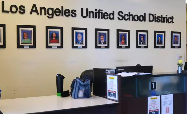 Photos of board members decorate the walls inside LAUSD headquarters Wednesday, Feb. 25, 2026, in Los Angeles. (AP Photo/Damian Dovarganes)