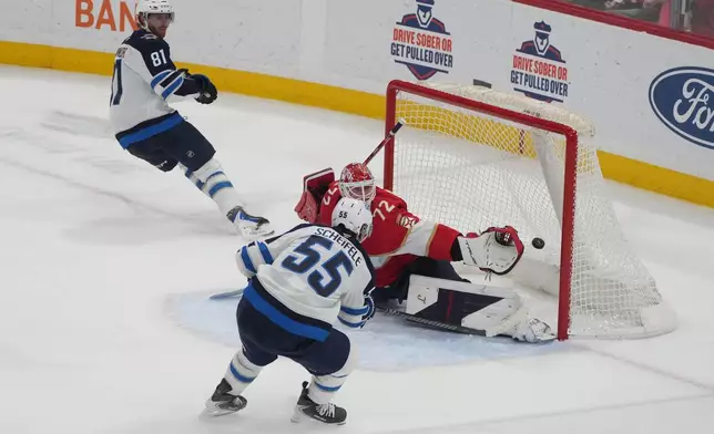Winnipeg Jets center Mark Scheifele (55) scores the game winning goal during the third period of an NHL hockey game against the Florida Panthers, Saturday, Jan. 31, 2026, in Sunrise, Fla. (AP Photo/Marta Lavandier)
