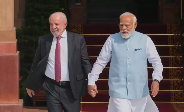 Indian Prime Minister Narendra Modi, right, walks with Brazilian President Luiz Inacio Lula da Silva for a photo call before their delegation level meeting in New Delhi, India, Saturday, Feb. 21, 2026. (AP Photo/Manish Swarup)