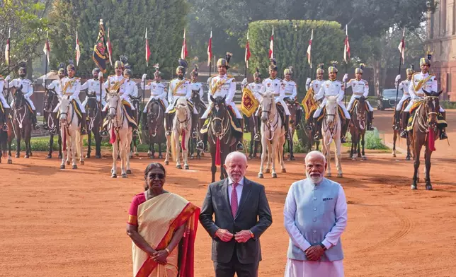 From left, Indian President Droupadi Murmu, left, with her Brazilian President Luiz Inacio Lula da Silva, center, and Indian Prime Minister Narendra Modi, pose for a photograph during the ceremonial reception of Lula da Silva, at the Presidential Palace in New Delhi, India, Saturday, Feb. 21, 2026. (AP Photo/Manish Swarup)