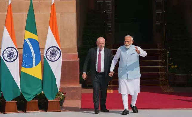 Indian Prime Minister Narendra Modi, right, walks with Brazilian President Luiz Inacio Lula da Silva for a photo call before their delegation level meeting in New Delhi, India, Saturday, Feb. 21, 2026. (AP Photo/Manish Swarup)