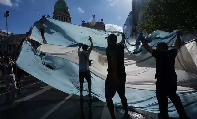 Protesters rally during a march by trade unions and opposition groups against a labor reform bill proposed by President Javier Milei's government in Buenos Aires, Argentina, Thursday, Feb. 19, 2026. (AP Photo/Rodrigo Abd)