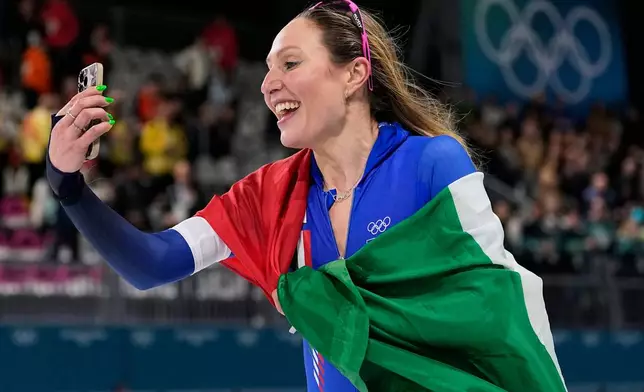 Francesca Lollobrigida of Italy celebrates winning the gold medal in the women's 5,000 meters speedskating race at the 2026 Winter Olympics, in Milan, Italy, Thursday, Feb. 12, 2026. (AP Photo/Ben Curtis)