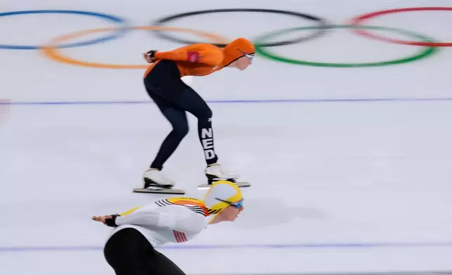 Sandrine Tas of Belgium, bottom, and Merel Conijn of the Netherlands compete in the women's 5,000 meters speedskating race at the 2026 Winter Olympics, in Milan, Italy, Thursday, Feb. 12, 2026. (AP Photo/Luca Bruno)