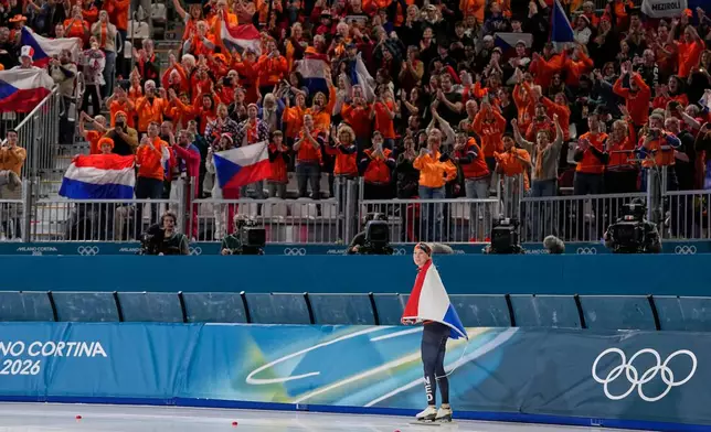 Merel Conijn of the Netherlands celebrates winning a silver medal with Dutch fans in the women's 5,000 meters speedskating race at the 2026 Winter Olympics, in Milan, Italy, Thursday, Feb. 12, 2026. (AP Photo/Ben Curtis)