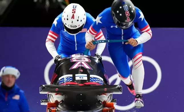 United States' Elana Meyers Taylor, right, and Jadin O'Brien start for a two women bobsled run at the 2026 Winter Olympics, in Cortina d'Ampezzo, Italy, Saturday, Feb. 21, 2026. (AP Photo/Aijaz Rahi)