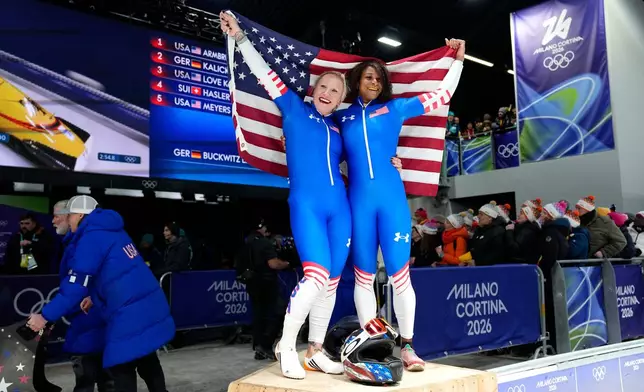 United States' Kaillie Armbruster Humphries, left, and Jasmine Jones arrive at the finish during a two women bobsled run at the 2026 Winter Olympics, in Cortina d'Ampezzo, Italy, Saturday, Feb. 21, 2026. (AP Photo/Alessandra Tarantino)