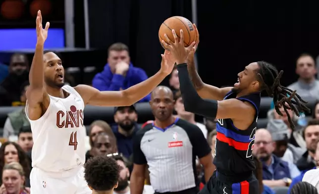 Detroit Pistons guard Daniss Jenkins, right, goes up for a shot against Cleveland Cavaliers center Evan Mobley (4) during the second half of an NBA basketball game Friday, Feb. 27, 2026, in Detroit. (AP Photo/Duane Burleson)