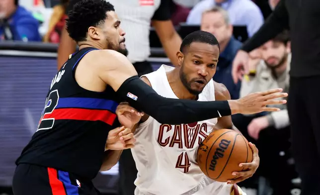 Cleveland Cavaliers center Evan Mobley (4) drives against Detroit Pistons forward Tobias Harris, left, during the second half of an NBA basketball game Friday, Feb. 27, 2026, in Detroit. (AP Photo/Duane Burleson)