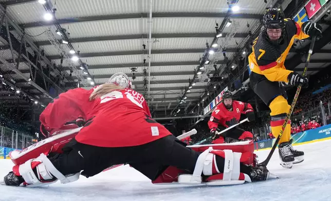 Germany's Franziska Feldmeier (7) scores her side's opening goal during a women's ice hockey quarterfinal game between Canada and Germany at the 2026 Winter Olympics, in Milan, Italy, Saturday, Feb. 14, 2026. (Sun Fei/Pool Photo via AP)