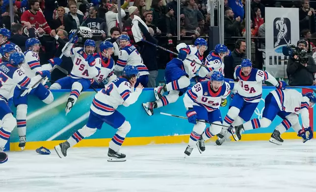 United States celebrate after defeating Canada in a men's ice hockey gold medal game between Canada and the United States at the 2026 Winter Olympics, in Milan, Italy, Sunday, Feb. 22, 2026. (AP Photo/Petr David Josek)