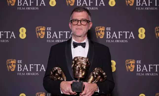 Paul Thomas Anderson poses with the awards for best director, cinematography, and adapted screenplay for 'One Battle After Another' at the 79th British Academy Film Awards, BAFTA's, in London, Sunday, Feb. 22, 2026. (AP Photo/Alastair Grant)