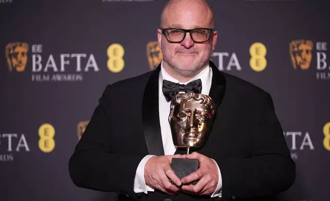 Michael Bauman poses with the award for cinematography for 'One Battle After Another' at the 79th British Academy Film Awards, BAFTA's, in London, Sunday, Feb. 22, 2026. (AP Photo/Alastair Grant)