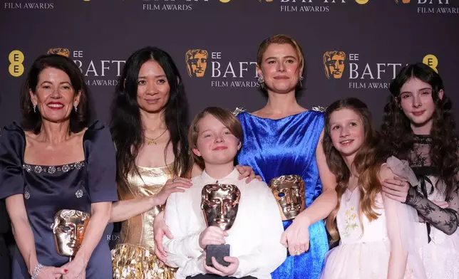Pippa Harris, from left, Chloe Zhao, Jacobi Jupe, Jessie Buckley, Olivia Lynes, and Bodhi Rae Breathnach pose with the award for outstanding British film for 'Hamnet' at the 79th British Academy Film Awards, BAFTA's, in London, Sunday, Feb. 22, 2026. (AP Photo/Alastair Grant)