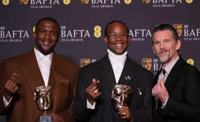 Wale Davies, from left, Akinola Davies Jr., and Ethan Hawke pose with the award for outstanding debut by a British writer, director or producer for 'My Father's Shadow' at the 79th British Academy Film Awards, BAFTA's, in London, Sunday, Feb. 22, 2026. (AP Photo/Alastair Grant)