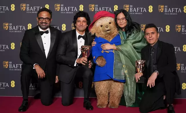 Alan McAlex, from left, Farhan Akhtar, Paddington Bear, Lakshmipriya Devi, and Ritesh Sidhwani pose with the award for children's &amp; family film for 'Boong' at the 79th British Academy Film Awards, BAFTA's, in London, Sunday, Feb. 22, 2026. (AP Photo/Alastair Grant)