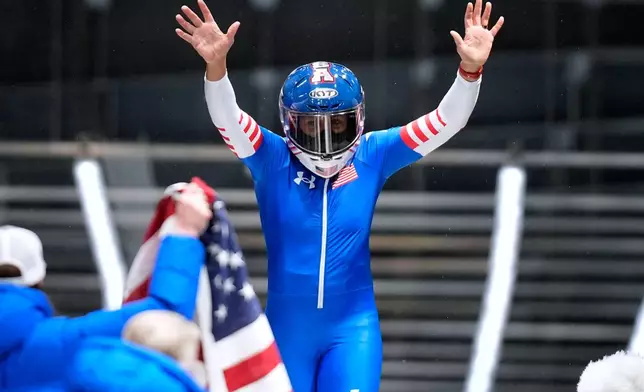 United States' gold medalist Elana Meyers Taylor celebrates at the finish after the women's monobob competition at the 2026 Winter Olympics, in Cortina d'Ampezzo, Italy, Monday, Feb. 16, 2026.(AP Photo/Aijaz Rahi)