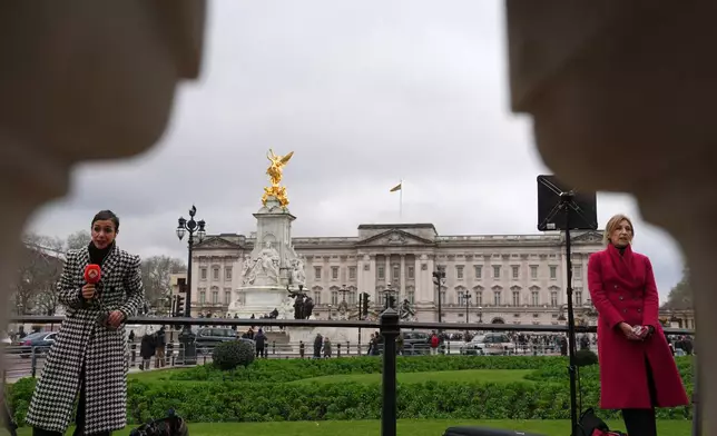 Reporters stand in front of Buckingham Palace in London, Thursday, Feb. 19, 2026 after Andrew Mountbatten-Windsor was arrested by British police on suspicion of misconduct in public office. (AP Photo/Kin Cheung)