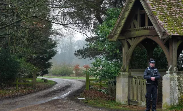 A Police officer guards the entrance to Wood Farm at the Sandringham Royal Estate in Sandringham, England, Thursday, Feb. 19, 2026 after Andrew Mountbatten-Windsor was arrested by British police on suspicion of misconduct in public office. (AP Photo/Alastair Grant)