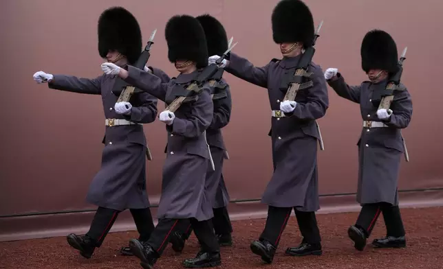 Soldiers exercise at Buckingham Palace in London, Thursday, Feb. 19, 2026 after Andrew Mountbatten-Windsor has been arrested by British police on suspicion of misconduct in public office. (AP Photo/Kin Cheung)