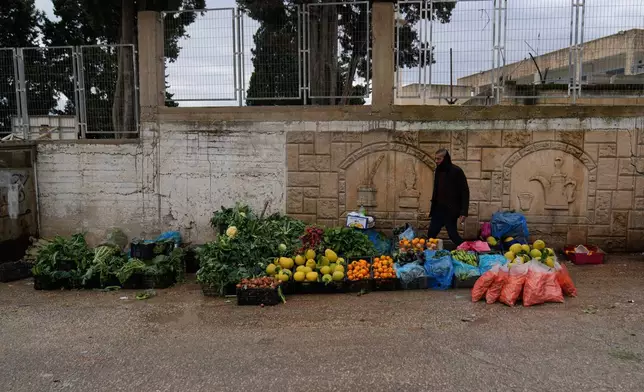 A Palestinian street vendor displays fruits and vegetables for sale in the West Bank city of Tulkarem Sunday, Jan. 18, 2026. (AP Photo/Nasser Nasser)