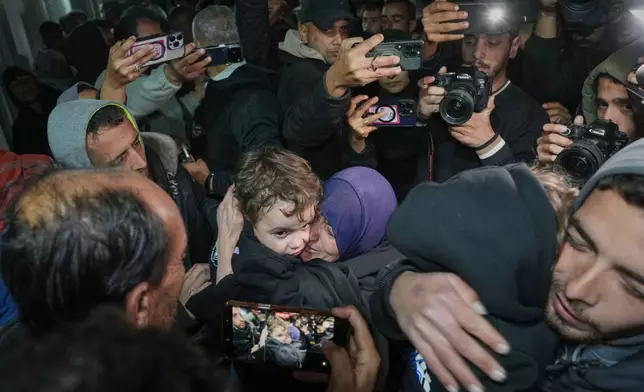 Najat Rubaie, center right, embraces one of her grandsons after they arrive with their mother as part of a group of about a dozen Palestinian returnees allowed into Gaza following the long-awaited reopening of the Rafah border crossing, at Nasser Hospital in Khan Younis, southern Gaza Strip, early Tuesday, Feb. 3, 2026. (AP Photo/Abdel Kareem Hana)