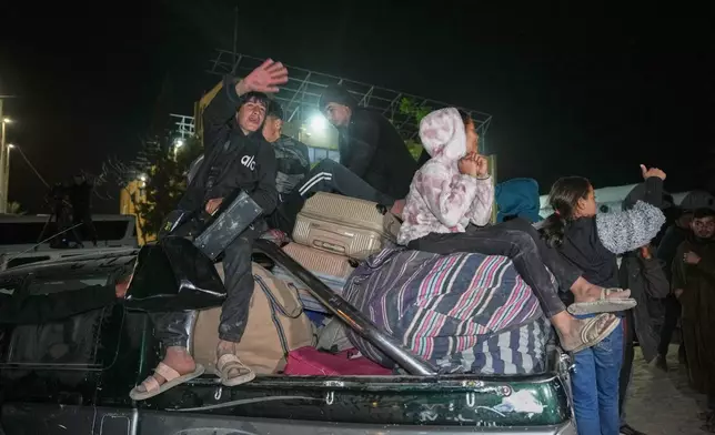 The family of Huda Abu Abed, a 60-year-old heart patient, carries her belongings after she and 11 other returnees were allowed into Gaza from Egypt following the long-awaited reopening of the Rafah border crossing, at Nasser Hospital in Khan Younis, southern Gaza Strip, early Tuesday, Feb. 3, 2026. (AP Photo/Abdel Kareem Hana)