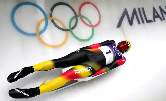 Germany's Max Langenhan slides down the track during a men's single luge training session at the 2026 Winter Olympics, in Cortina d'Ampezzo, Italy, Saturday, Feb. 7, 2026. (AP Photo/Aijaz Rahi)