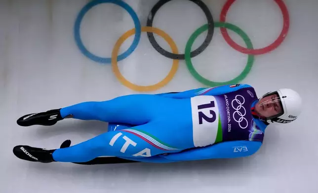 Italy's Dominik Fischnaller slides down the track during a men's single luge run at the 2026 Winter Olympics, in Cortina d'Ampezzo, Italy, Saturday, Feb. 7, 2026. (AP Photo/Aijaz Rahi)