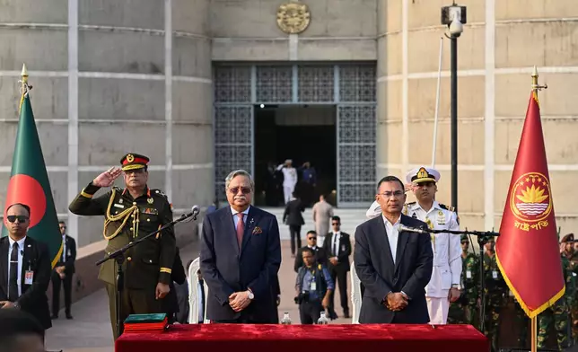 Tarique Rahman, Chairperson of the Bangladesh Nationalist Party, right, stand with Bangladesh President Mohammed Shahabuddin for national anthem after Rahman was sworn in as country's prime minister during a ceremony at the National Parliament in Dhaka, Bangladesh, Tuesday, Feb.17, 2026. (AP Photo/Mahmud Hossain Opu)