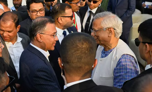 Chief Advisor of Bangladesh Professor Muhammad Yunus, right, congratulates Bangladesh's newly sworn in Prime Minister Tarique Rahman, after swearing in ceremony at the National Parliament in Dhaka, Bangladesh, Tuesday, Feb.17, 2026. (AP Photo/Mahmud Hossain Opu)