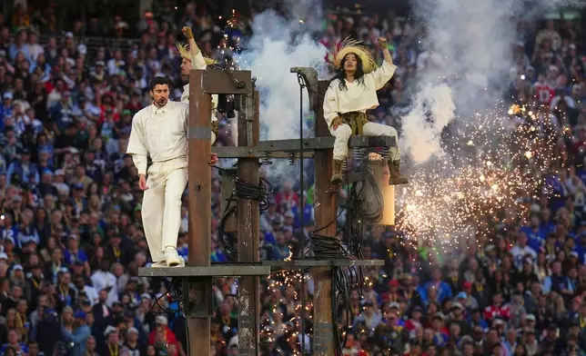 Bad Bunny, left, performs during halftime of the NFL Super Bowl 60 football game between the New England Patriots and the Seattle Seahawks, Sunday, Feb. 8, 2026, in Santa Clara, Calif. (AP Photo/Godofredo A. Vásquez)