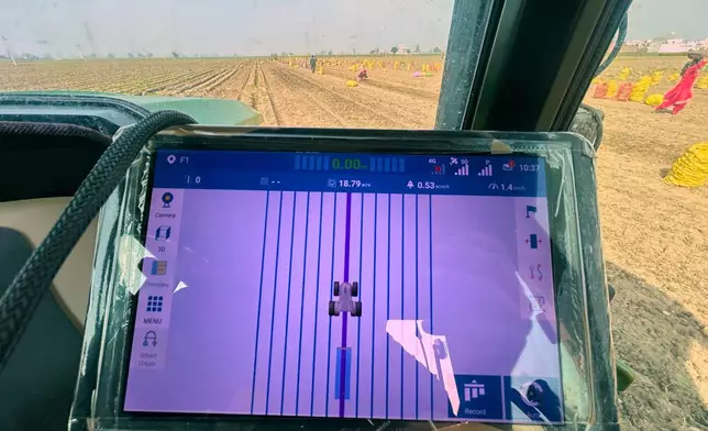 An AI-operated driverless tractor is used to harvest potatoes at a farm near Karnal, India, on Feb. 10, 2026. (AP Photo/Piyush Nagpal)