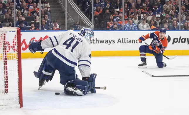 Toronto Maple Leafs' goalie Anthony Stolarz (41) makes a save on Edmonton Oilers' Ryan Nugent-Hopkins (93) during the second period of an NHL hockey game, in Edmonton, Alberta, Tuesday, Feb. 3, 2026. (Jason Franson/The Canadian Press via AP)