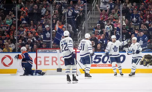 Toronto Maple Leafs' Matias Maccelli (63) celebrates his goal with teammates Jake McCabe (22), John Tavares (91) and Matthew Knies (23) as Edmonton Oilers' goalie Connor Ingram (39) looks on during the second period of an NHL hockey game, in Edmonton, Alberta, Tuesday, Feb. 3, 2026. (Jason Franson/The Canadian Press via AP)