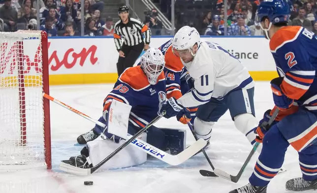 Toronto Maple Leafs' Max Domi (11) is stopped by Edmonton Oilers' goalie Connor Ingram (39) during first period NHL action, in Edmonton on Tuesday, Feb. 3, 2026. (Jason Franson/The Canadian Press via AP)